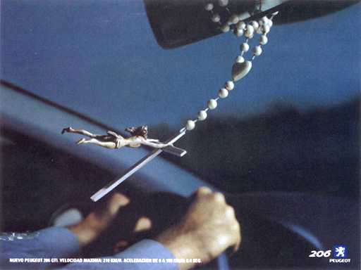 jesus hanging from a cross on a chain hanging from a rear view mirror
