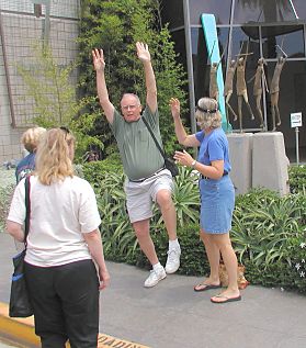 Getting ready to imitate the five dancers statue, Paul with his hands in the air.