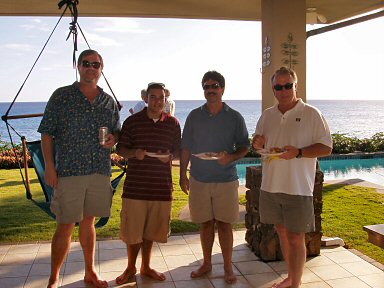 four men in front of the ocean