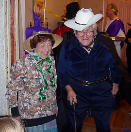 woman in gardening glothes and zorro in white hat