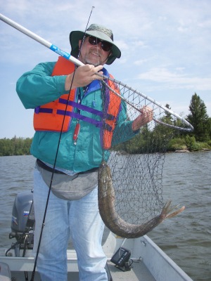 Jim holding a net with a 33 inch pike in it.
