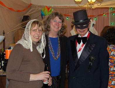 two women and a man in costume. man in top hat