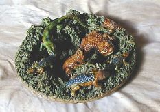 Pallisy  ware plate with frogs, lizards, and snakes. Colored dark green, blue and brown. Ugly!