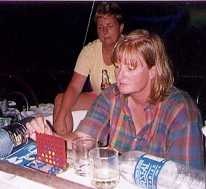 two girls in cockpit of a yacht at night, naked