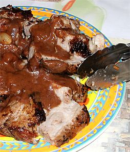 pork butt with prunes, sliced with a sauce on them